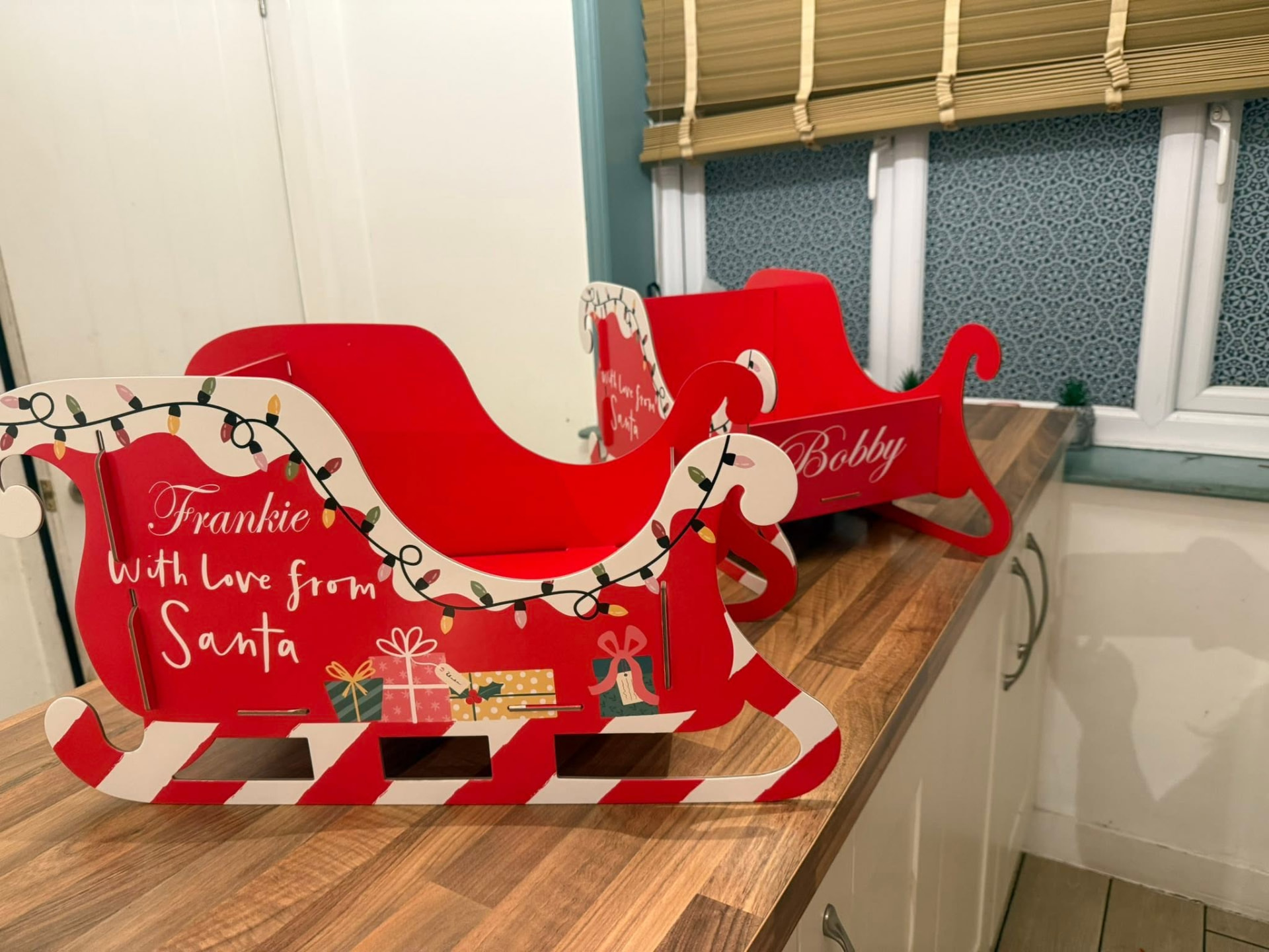 Personalised red wooden Santa sleighs for Frankie and Bobby