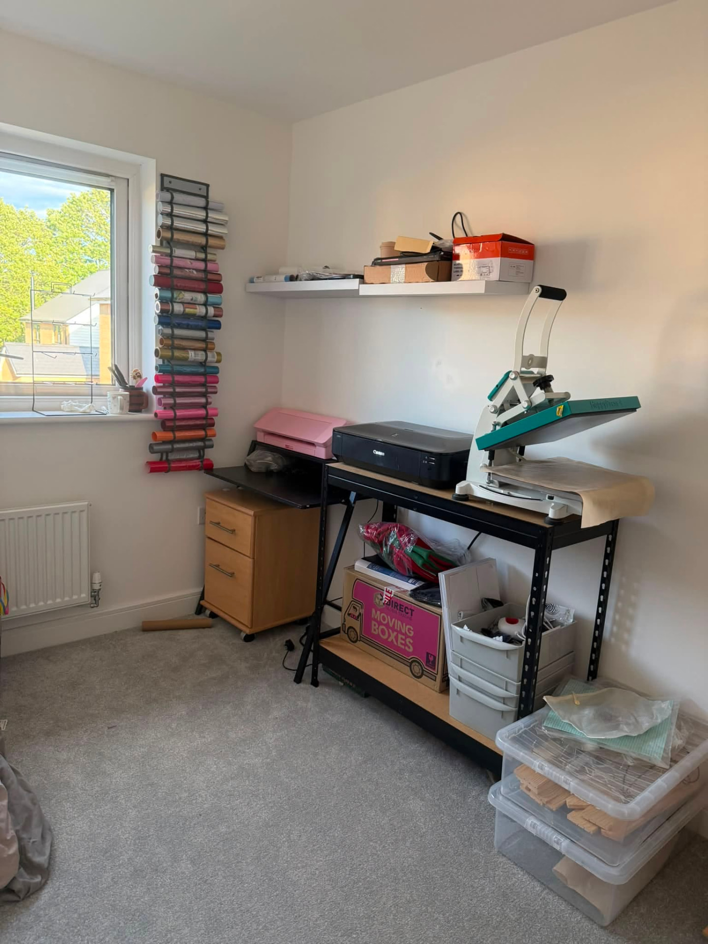 Home print studio with heat press, Canon printer, Cricut cutter and rolls of coloured vinyl